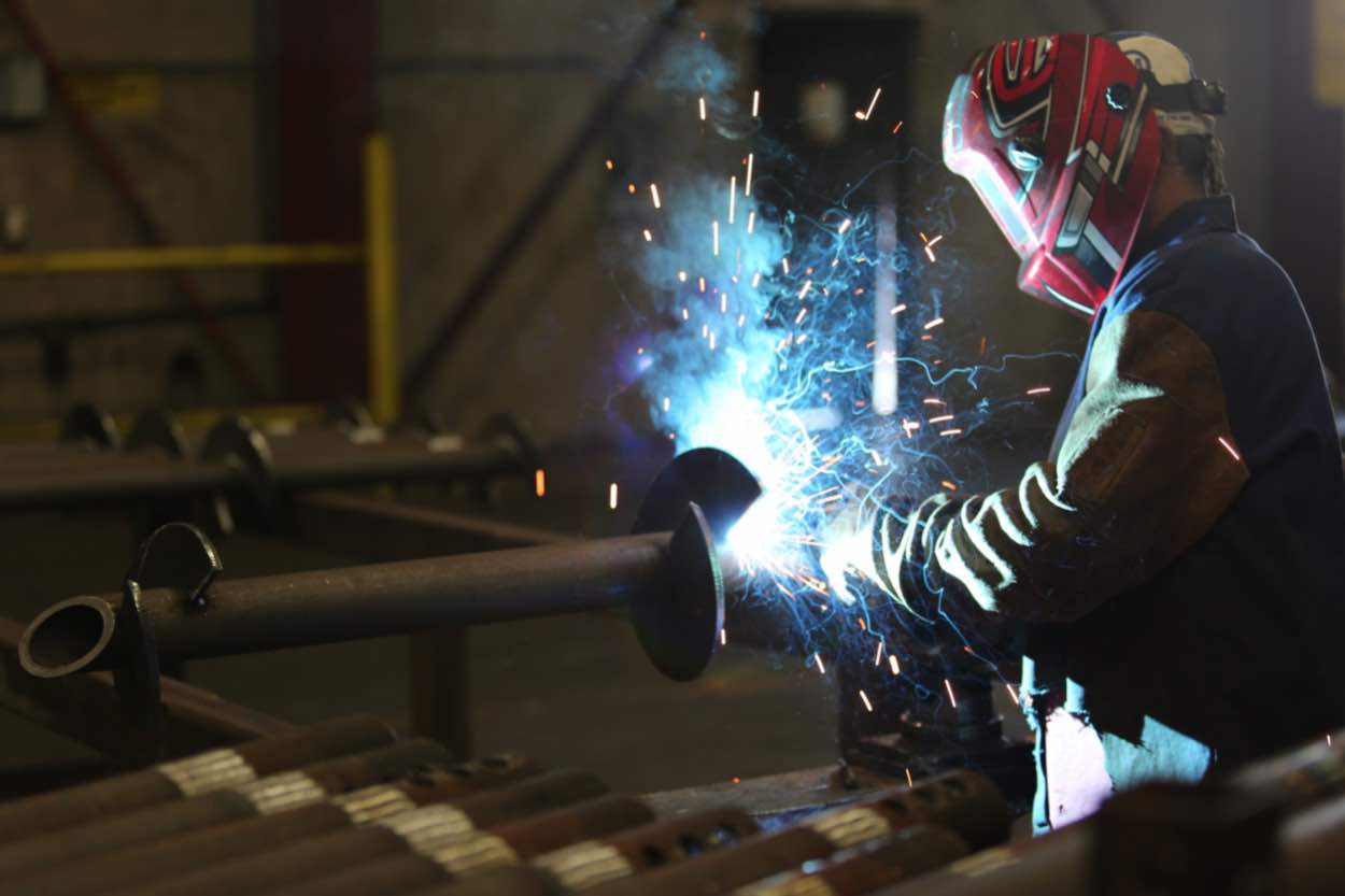 A welder working on a pile